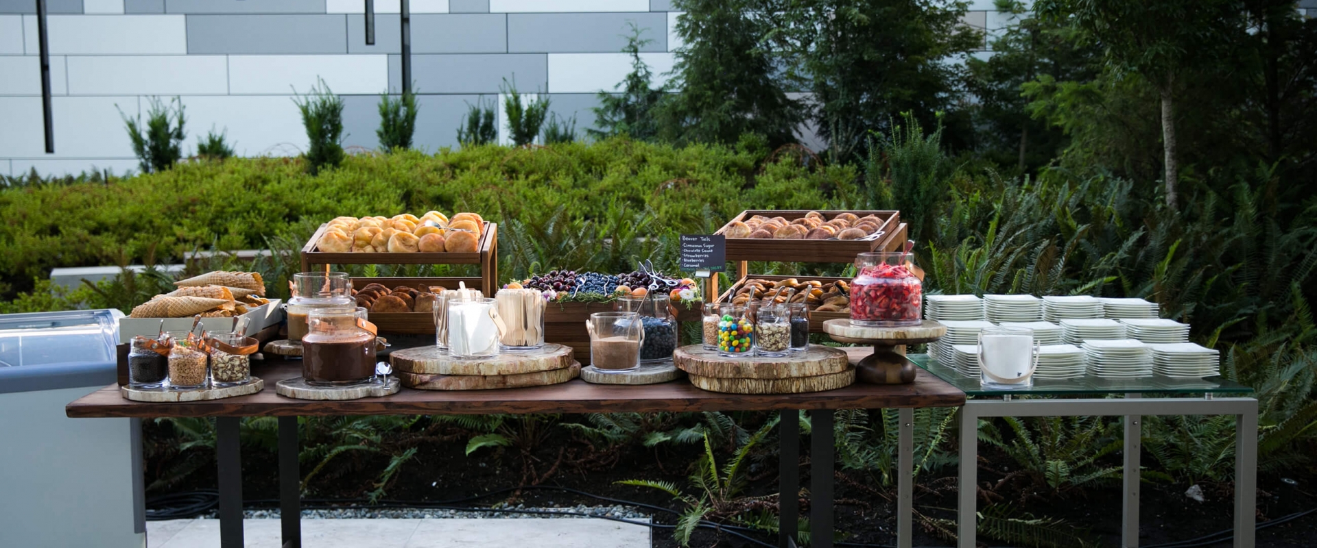 assortment of desserts & snacks on a long table at Parq Vancouver